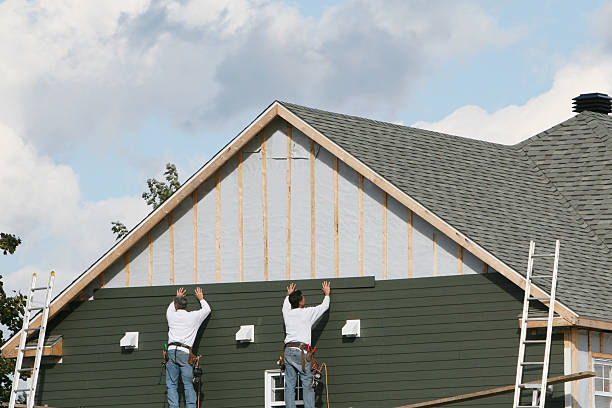 Professional Siding technician working in Mineola, NY